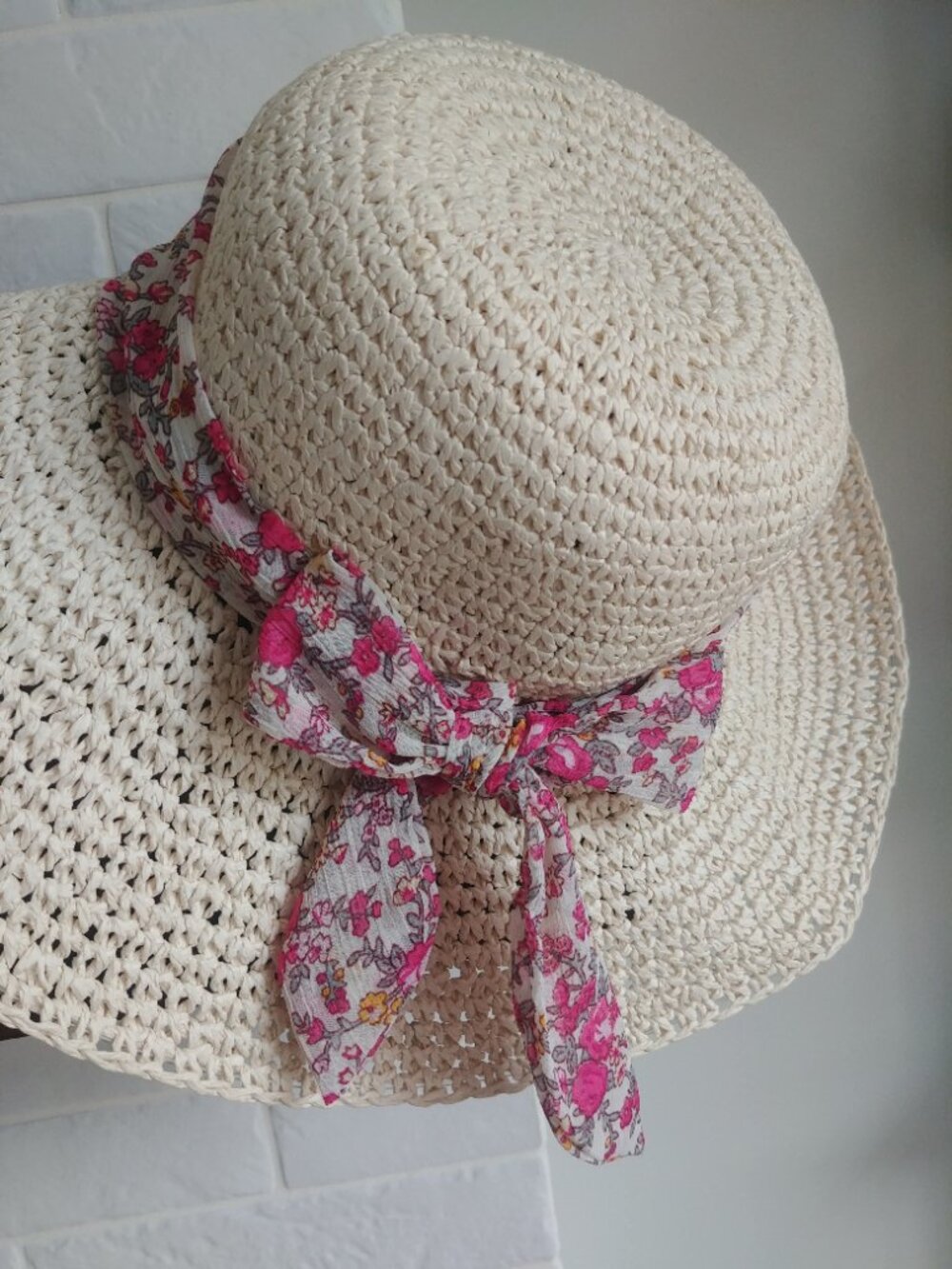 Pale tan cream straw paper floppy summer hat with pink floral bow and ribbon